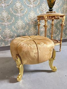 an ornately decorated chair and foot stool in gold