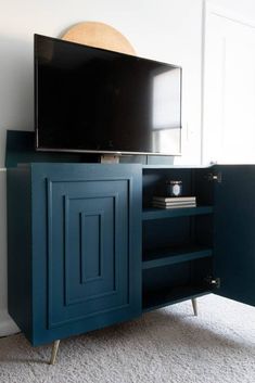 an entertainment center with a flat screen tv on it's sideboard in a living room