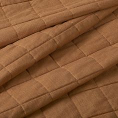 an image of a brown quilted material that looks like it has been made from fabric