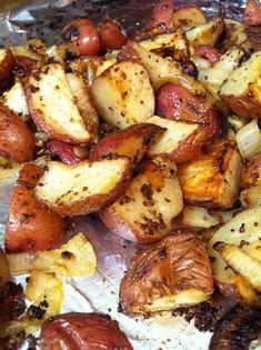 the potatoes and sausages have been cooked in tin foil with seasoning sprinkled on them