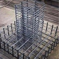 several steel bars are stacked on top of each other in the middle of an outdoor area