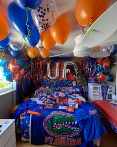 a bed room with balloons and decorations on the ceiling for florida football fans to celebrate