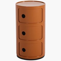 an orange three - drawered side table with black dots