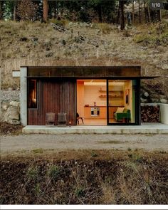 a small house sitting on top of a hill