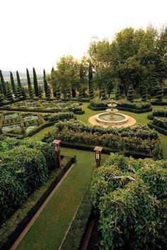 a formal garden is shown in the middle of an area with many hedges and trees