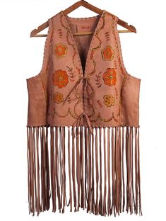 Introducing our 70's vintage-inspired, hand-painted leather fringe vest. This vest is crafted from genuine goat leather and features unique front hand-painting, adding a touch of artistic flair to this piece. The jacket is also hand-sewn for added durability and quality. It comes in the rich salmon pink color. The vest has a fringe detail on the back, adding an extra touch of bohemian style.  Add a touch of vintage charm to your wardrobe with this one-of-a-kind leather fringe vest. The jacket is available in personalized custom sizes. Please message us for further information. Vintage Wishlist, Leather Fringe Vest, Vintage Leather Vest, Surface Pattern Design Inspiration, Salmon Pink Color, Western Vest, Fringe Vest, Book Clothes, Hand Painted Leather