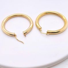 These stunning polished 14k yellow gold hoops provide a look that is both trendy and classic. While they were once worn by kings and queens to signify power and social status, hoop earrings are now considered a statement of unity and strength. Hoop earrings stand out, just like the strong people who sport them. These earrings are a great staple to add to your collection, and can be worn with both casual and formal wear. These hoop earrings would make the perfect gift for your loved one of yourse Luxury Round Hoop Earrings For Everyday, Timeless Gold Plated Hoop Earrings For Anniversary, Timeless Gold Plated Hoop Earrings, Classic Gold Plated Polished Hoop Earrings, Gold Small Hoop Classic Rings, Small Hoop Gold Classic Rings, Classic Small Hoop Gold Rings, Classic Gold Plated Hoop Earrings With Polished Finish, Classic Gold Hoop Huggie Earrings