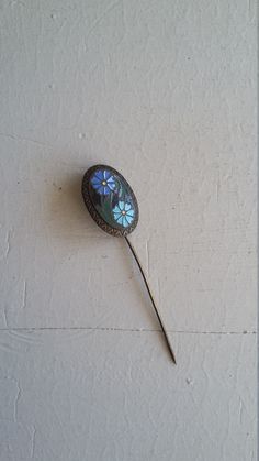 This antique floral hat pin is lovely! The hat pin has two inlaid flowers set in an oval flat face . Made of metal. A great pin for a coat or heavy sweater. ------------------------------------------------------------------------------------------- Condition: Very Good Condition for it's age There is wear. There's a slight bend to the steam.  Era: Appears to be 1920's - 1930's  Measurements: 2" length; oval face: 5/8" width x 7/8 Maker Marking: n/a --------------------------------------------------------------------------------------------- ★ Special packaging, delivery and tracking are included in shipping cost. ★ Cleaned prior to shipment and ready to wear. Alterations and repairs are completed when necessary. ★ visit our shop at: ★ https://www.etsy.com/shop/VivianVintage8 ★ refer to our Pin Hat, Flat Face, Heavy Sweaters, Floral Hat, Antique Floral, Floral Pins, Oval Face, Hat Pin, Vintage Hat