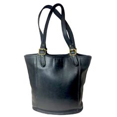 Vintage Coach Black Glove Tanned Cowhide Large Shopper Shoulder Bag No E7c-9090 Vintage Coach Large Shopper Shoulder Bag Black Glove Tanned Cowhide Leather Adjustable Shoulder Straps Brass Hardware Interior Has Both The Original Leather And Suede Lining Both Sides Have Leather Flaps With Pockets For Organization One Side Has The Coach Creed And A Zipper Pocket The Other Side Has An Open Slip Pocket The Coach Shopper Comes In Two Distinct Sizes This Is The Larger Of The Two Sizes Exterior Has Been Carefully Cleaned With Leather Conditioner And The Hardware Polished By Hand Original Straps And Hardware Are All Intact Condition: Vintage Shoulder Bag Never Having Been Repaired Creed Reads: E7c Tan Cowhide, Vintage Shoulder Bag, Black Gloves, Vintage Bag, Leather Conditioner, Shoulder Bag Black, Vintage Coach, Vintage Bags, Brass Hardware