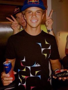 a young man holding up two fingers in front of his face and the caption that says julian wilson, 24 year old pro surfer from australia oh my god