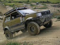 an off - road vehicle is driving through the mud