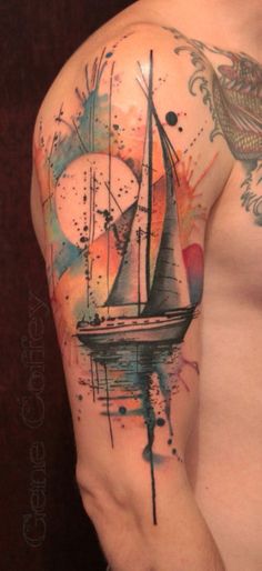 a man's arm with a watercolor tattoo on it and a sailboat in the background