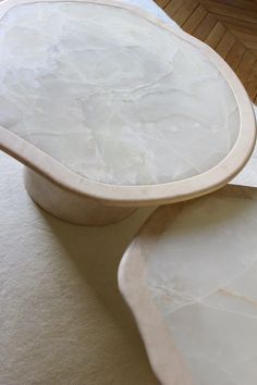 two white bowls sitting on top of a table