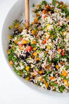 a white bowl filled with rice and vegetables