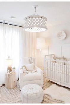 a baby's room with white furniture and curtains