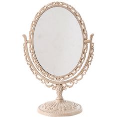 an ornately designed vanity mirror on a stand