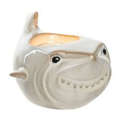 a ceramic toothbrush holder in the shape of a fish with its mouth wide open