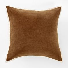 a brown and white pillow on a white background