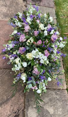 a bouquet of flowers sitting on top of a stone walkway