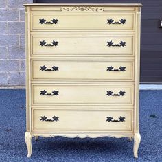 an old dresser is painted yellow and black