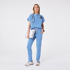 Official FIGS® Scrubs. Ridiculously Soft Scrubs Designed Just For You. Get Free Shipping On Orders $50+! | FIGS Womens Ceil Blue Montex - Mock Neck Scrub Top Poses In Scrubs, Figs Scrubs Aesthetic, Light Blue Scrubs, Green Figs Scrubs, Royal Blue Figs Scrubs, Ciel Blue Scrubs, Dark Blue Scrubs, Ceil Blue Scrubs, Teal Scrubs Nursing