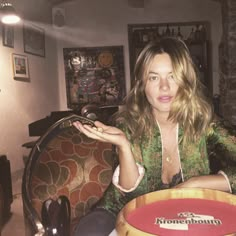 a woman sitting at a table with a plate in her hand