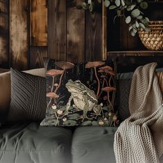 a couch with a pillow on top of it next to a potted plant and other items