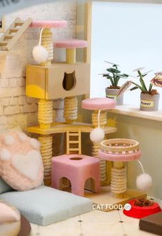 a cat house made out of cardboard and stuffed animals is shown in the foreground