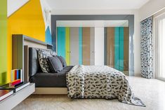 a bedroom with multicolored walls and a bed