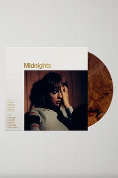 an album cover with a woman holding her hand to her face and the words midnights on it