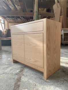 a large wooden cabinet sitting on top of a floor next to a pile of boxes