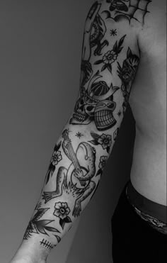 black and white photo of a man's arm with tattoo designs on it,