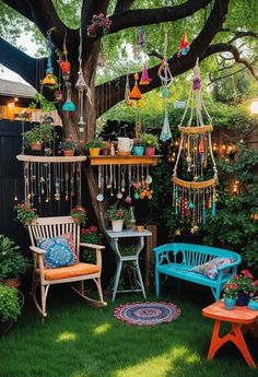 an outdoor area with chairs, potted plants and wind chimes hanging from the tree