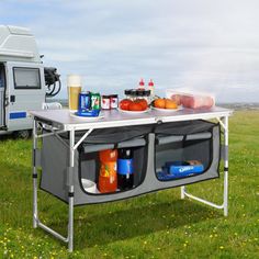 a camper trailer with food and drinks on the table