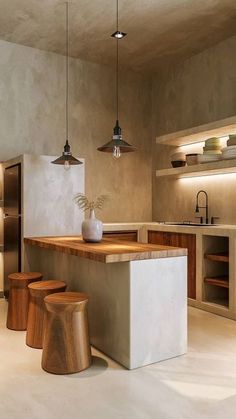 a kitchen with an island and stools in it