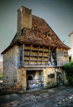 an old brick building with a wooden roof