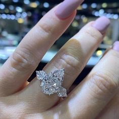 a woman's hand with a diamond ring on it