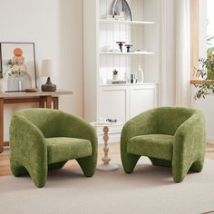 two green chairs sitting on top of a rug in front of a white wall and floor