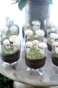 small cups filled with food sitting on top of a table