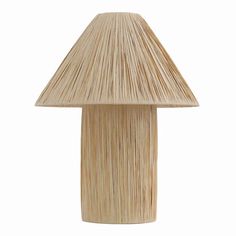 a wooden table lamp with a large mushroom shaped shade on it's top, against a white background