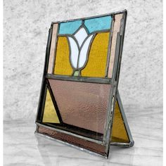 an old stained glass window on a marble surface