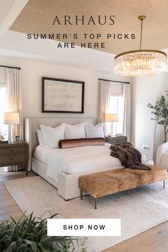 a large white bed sitting in a bedroom next to a window