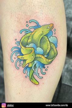 an image of a tattoo on the leg of a person with two fish in it