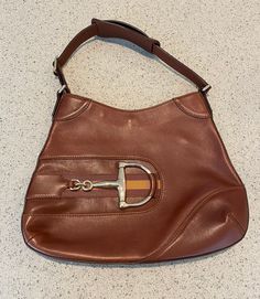 This classic Gucci Web Horsebit Hobo purse is brown leather with a great horsebit feature on the front. The leather strap measures 16 inches. The purse measures 13 1/2 x 10 1/2 inches. The interior of the purse is in pristine condition. There are a few small marks on the front of the purse- see photos. No dust bag, cards or receipt available. Please go to my shop- Carter Jewelry22- for more fabulous vintage and antique pieces! Also follow me on Instagram at CarterJewelry. Classic Business Shoulder Bag With Horsebit Detail, Classic Horsebit Shoulder Bag For Business, Designer Bag With Horsebit Detail, Designer Business Bags With Horsebit Detail, Classic Brown Shoulder Bag With Horsebit Detail, Brown Business Bag With Horsebit Detail, Brown Office Shoulder Bag With Horsebit Detail, Brown Business Bags With Horsebit Detail, Brown Horsebit Detail Business Bag