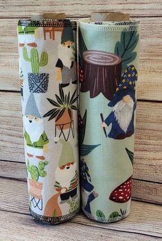 two fabric roll holders with different designs on them