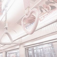 the inside of a subway car with pink decorations on it's ceiling and windows