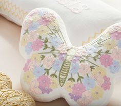 a decorative pillow sitting on top of a table next to cookies