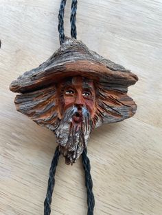 "This is a wild hand carved wooden bolo tie from the 1970's. It has the face of a bearded person and is intricately done. The tie is supple dark brown leather and the tips are a shiny brass colored metal. The wooden part measures 3 inches across and 3 inches high.  Tie measure 18\" (halved)" Handmade Bohemian Bolo Tie, Handmade Bolo Tie, Vintage Bolo Tie, Unique Handmade Adjustable Bolo Ties, Vintage Brown Bolo Tie With Adjustable Length, Bolo Tie, Wood Carvings, Dark Brown Leather, Whittling