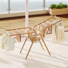 clothes are hanging out to dry in an open air room near the ocean and beach