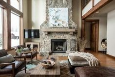 a living room with couches, chairs and a fireplace